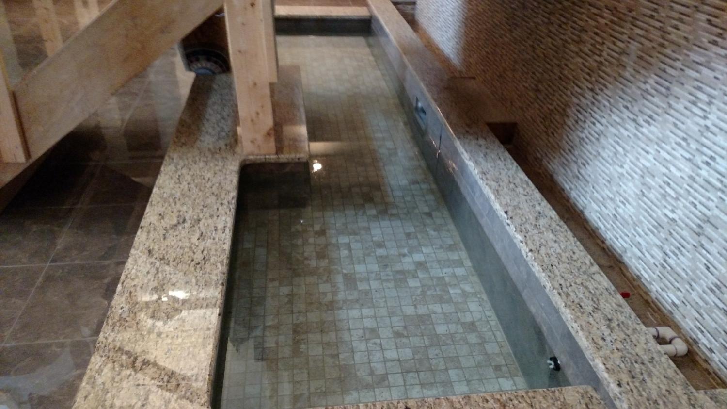 Tiled indoor pool with granite surround